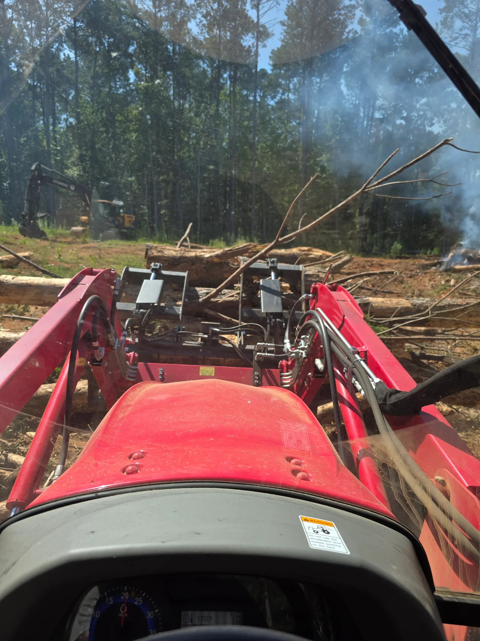 Debris removal truck loading cleared brush and waste