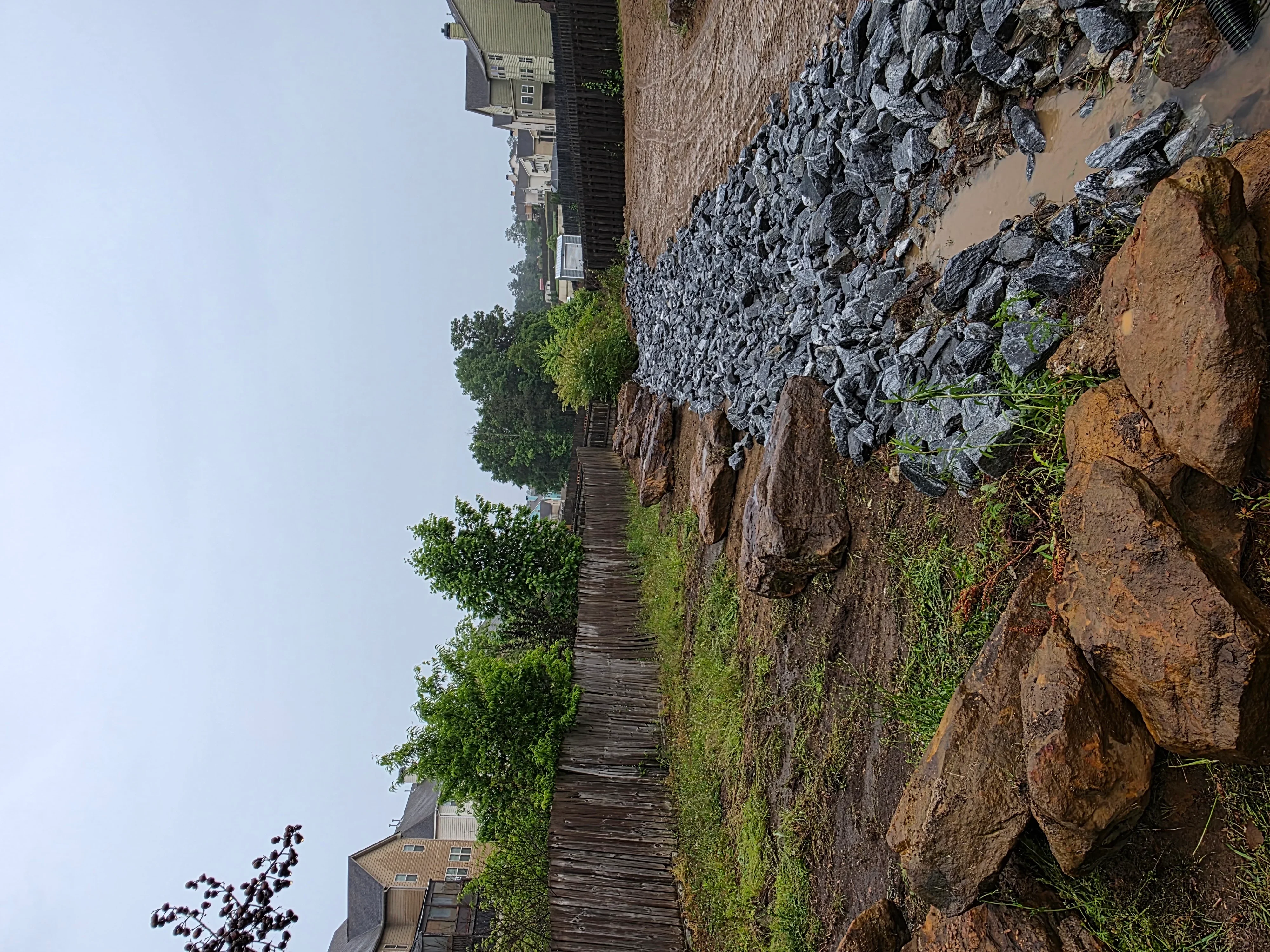 Demolished concrete foundation and rubble staged on cleared residential lot
